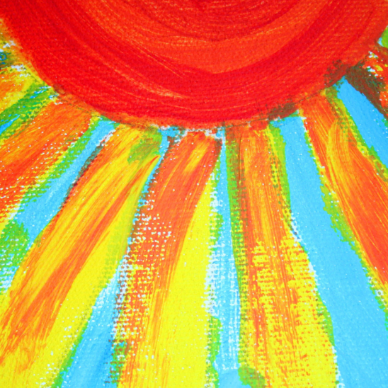 Red spot, as a sun, fanning out into golden yellow rays against blue