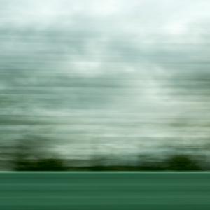 green pasture and trees at horizon line - motion blurred